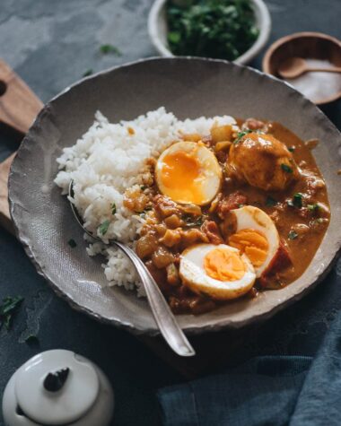 Egg curry served with steamed rice in a bowl