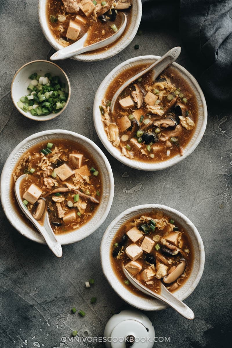 Hot and Sour Soup (酸辣汤) - Authentic Chinese restaurant-style hot and sour soup made easy. The hearty broth is loaded with veggies and is so satisfying and healthy. The recipe includes notes on how to tweak the soup into a vegetarian one and to use whatever veggies you have on hand. #takeout #recipes #traditional Homemade hot and sour soup in bowls