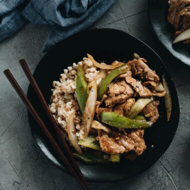 Pork Stir Fry with Pepper served on one plate with rice