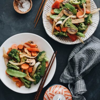 Stir fried vegetables including onion, broccoli, carrot, mushroom, bamboo shoot, and snow peas
