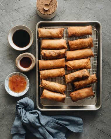 Fried Chinese egg rolls on cooling rack