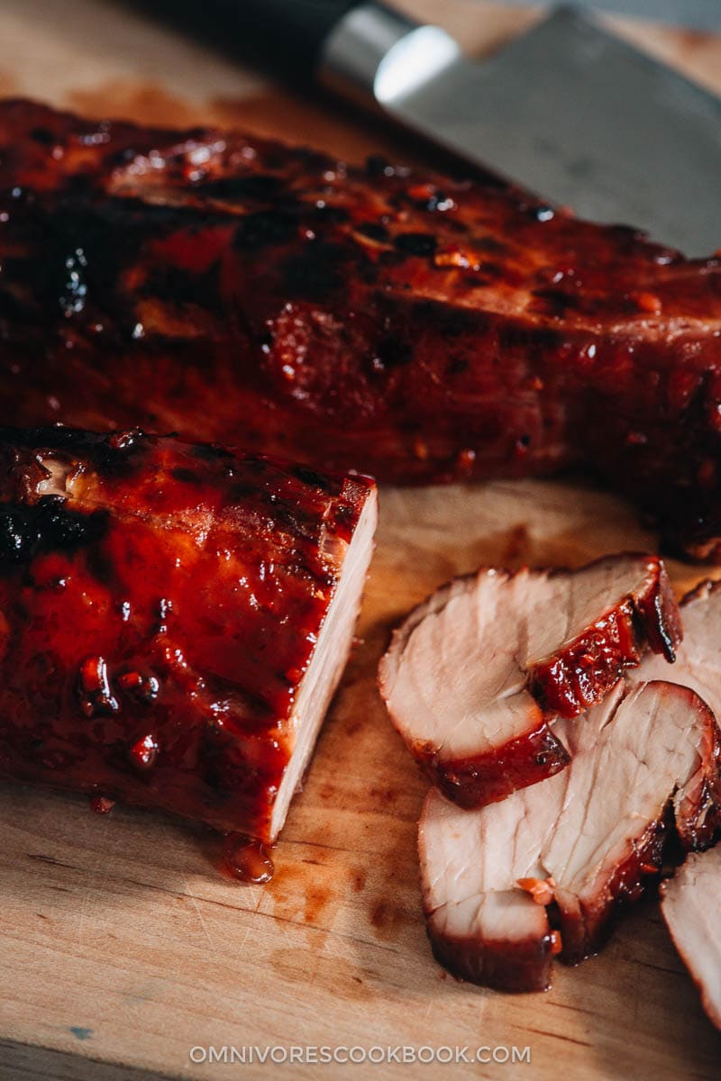 Char Siu (Chinese BBQ Pork, 叉烧肉) - The only char siu recipe you need to make juicy flavorful pork with a sweet glossy glaze, just like you’d get at a Cantonese restaurant. {Gluten-Free adaptable} Sliced Chinese BBQ pork on cutting board close-up