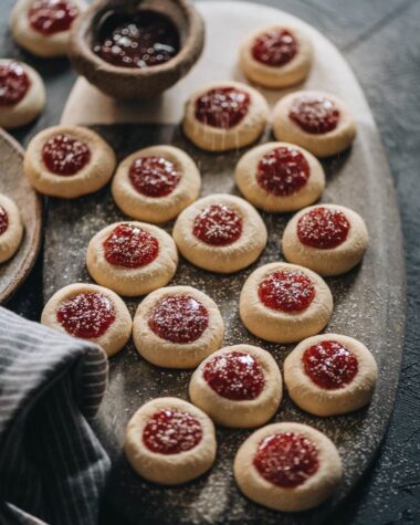 Strawberry thumbprint cookies dust with powdered sugar