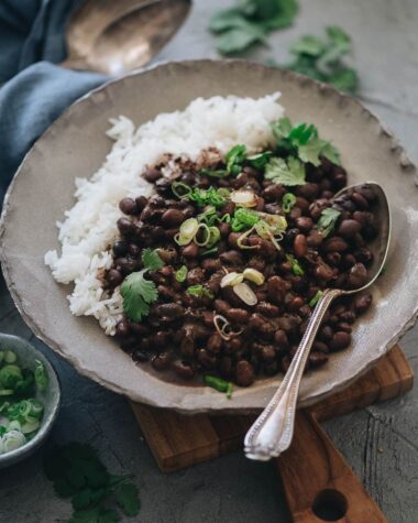 Black beans with rice garnished with cilantro and green onions
