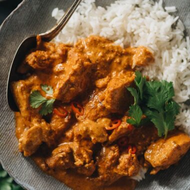Butter chicken served over rice close-up