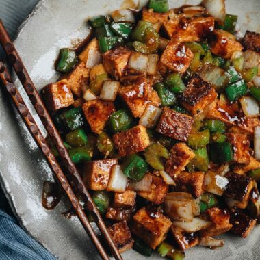 Close-up of crispy stir-fried tofu, green pepper, celery, and onion