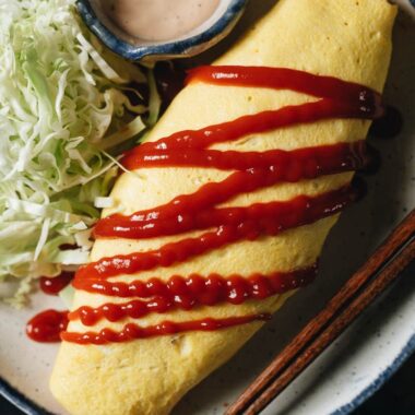 Kimchi fried rice omelet with tomato ketchup and cabbage salad