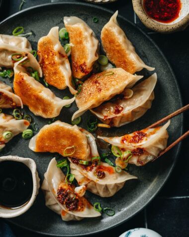 Pan fried dumplings with chili oil and scallion