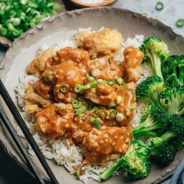 Crispy chicken with peanut butter sauce served with broccoli and rice