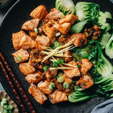 Pan fried salmon served with baby bok choy close up