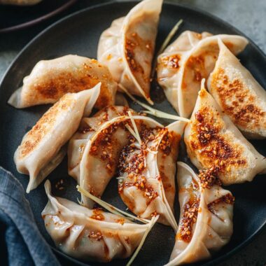 Chinese chicken dumplings served with dipping sauce and chili oil
