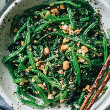 Chinese spinach salad with peanuts close up