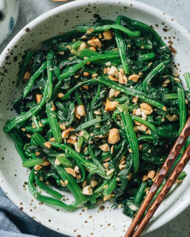 Chinese spinach salad with peanuts close up