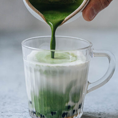 Pouring matcha to make matcha bubble tea