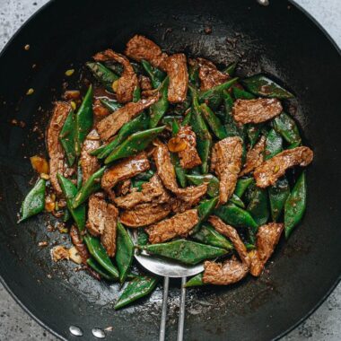 Steak and green beans stir fry in a wok