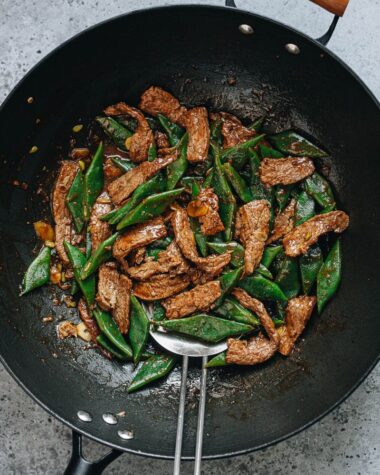 Steak and green beans stir fry in a wok