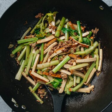 Dried tofu and celery stir fry in a wok