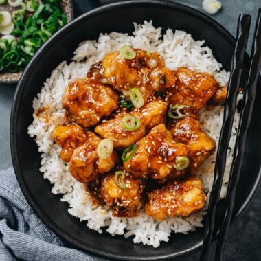 Crispy sesame chicken over steamed rice