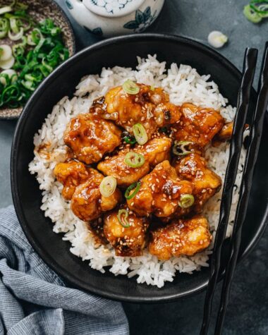 Crispy sesame chicken over steamed rice