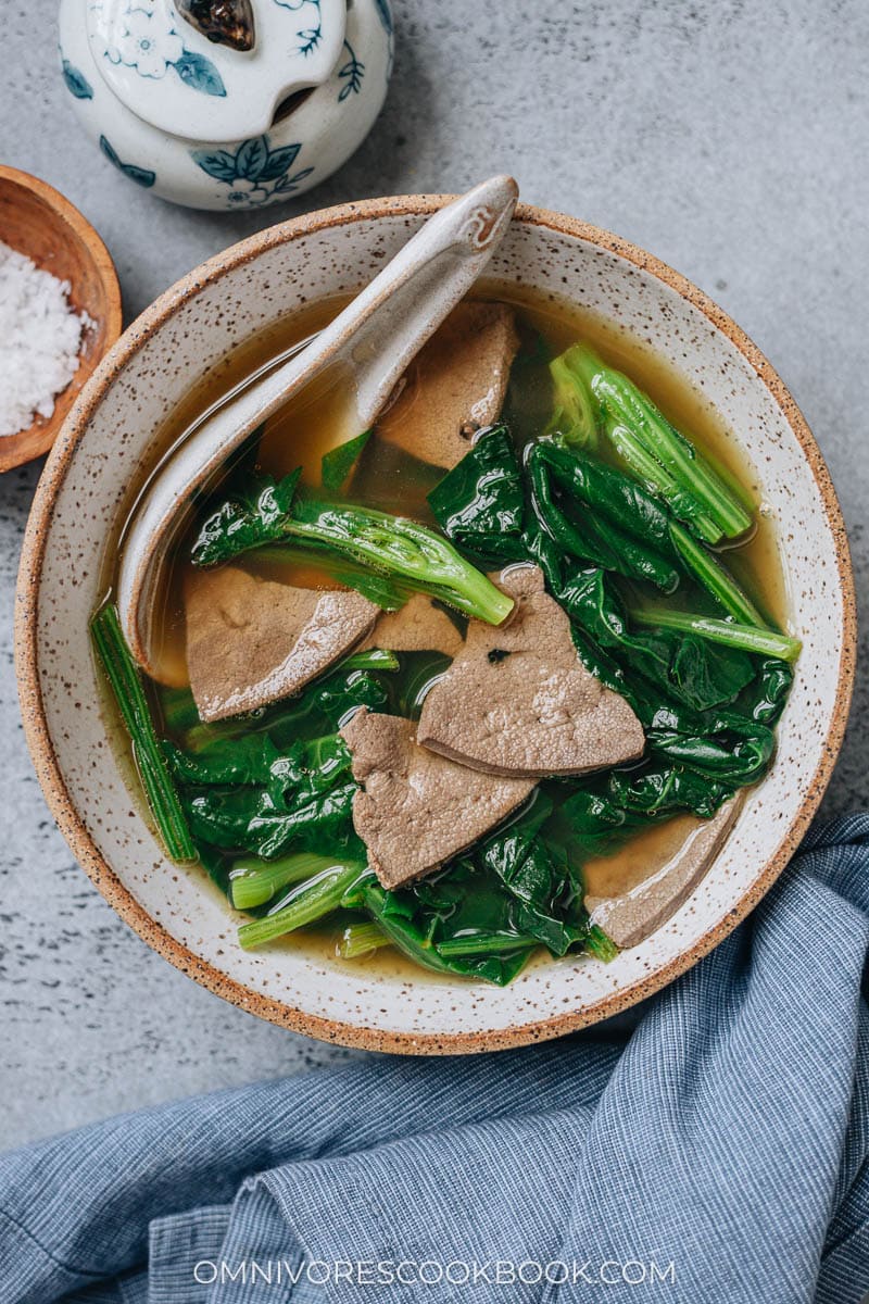 Pork liver soup with spinach in a bowl