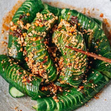Picking up spiral cut cucumber with spicy sauce