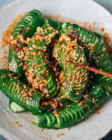 Picking up spiral cut cucumber with spicy sauce