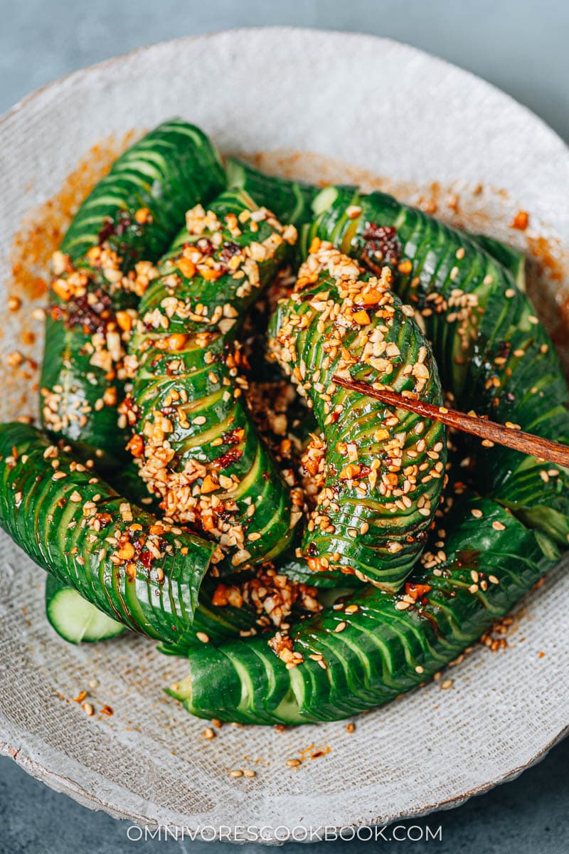 Picking up spiral cut cucumber with spicy sauce