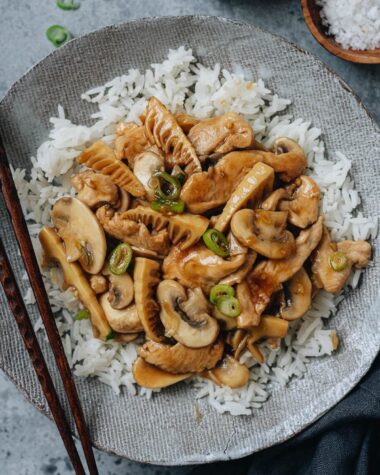 Mushroom chicken stir fry over rice close up