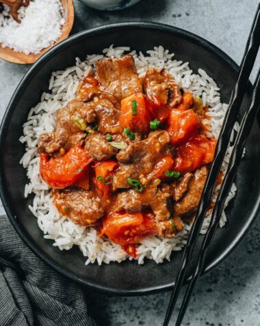 Beef and tomato stir fry topped over steamed rice