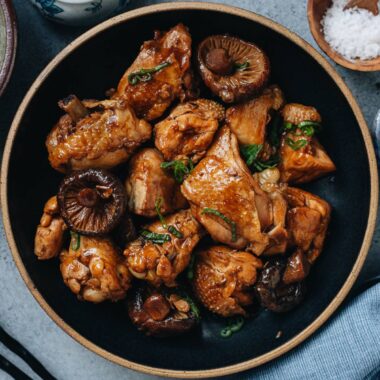 Chinese braised chicken with mushrooms is a classic Northern Chinese dish that is comforting and satisfying. Bone-in chicken pieces are braised in a savory broth with mushrooms to create a potent sauce that enhances them both. The mushrooms are the highlight of the dish, meaty and juicy, and add an earthy umami to the tender chicken.