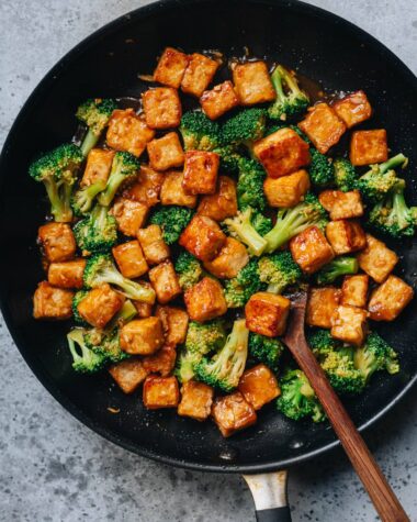 Tofu with broccoli in brown sauce in frying pan