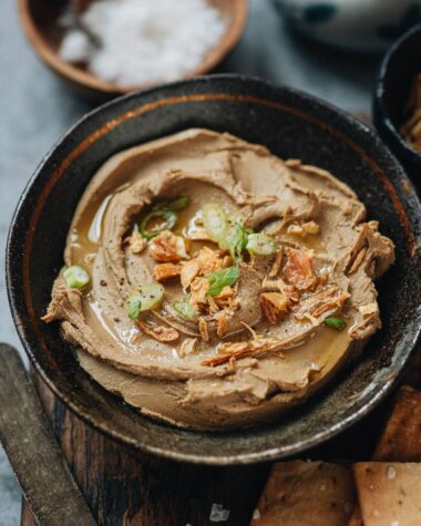 Chicken liver pâté served in a bowl with shallot, scallion and olive oil