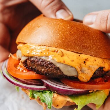 Holding a lamb burger with hands