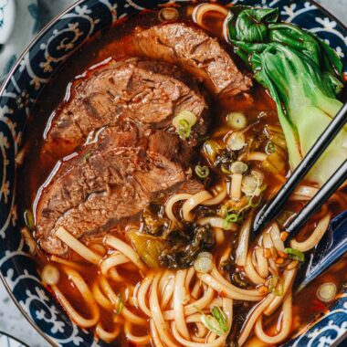 Taiwanese beef noodle soup with bok choy and mustard greens